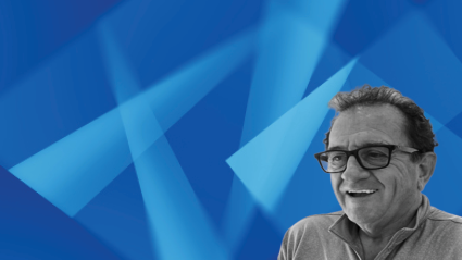 Man wearing glasses against blue geometric background